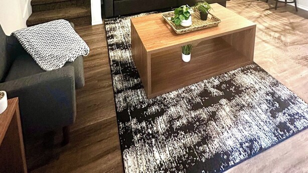 A living room with a sofa, coffee table, and a staircase. - [HB102] New 3BR near JBSA, Randolph Airforce Base I Fully Stocked + Parking (San Antonio)