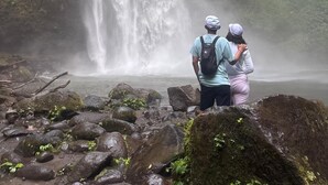 A waterfall in a forested area with rocks and moss. - Tikumbar - Glamping, Cafe, Camping Ground & Campervan (Pelaga)