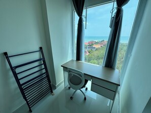 A room with a desk, chair, and a window with curtains. - Nam Talay by PSR (Nongprue)