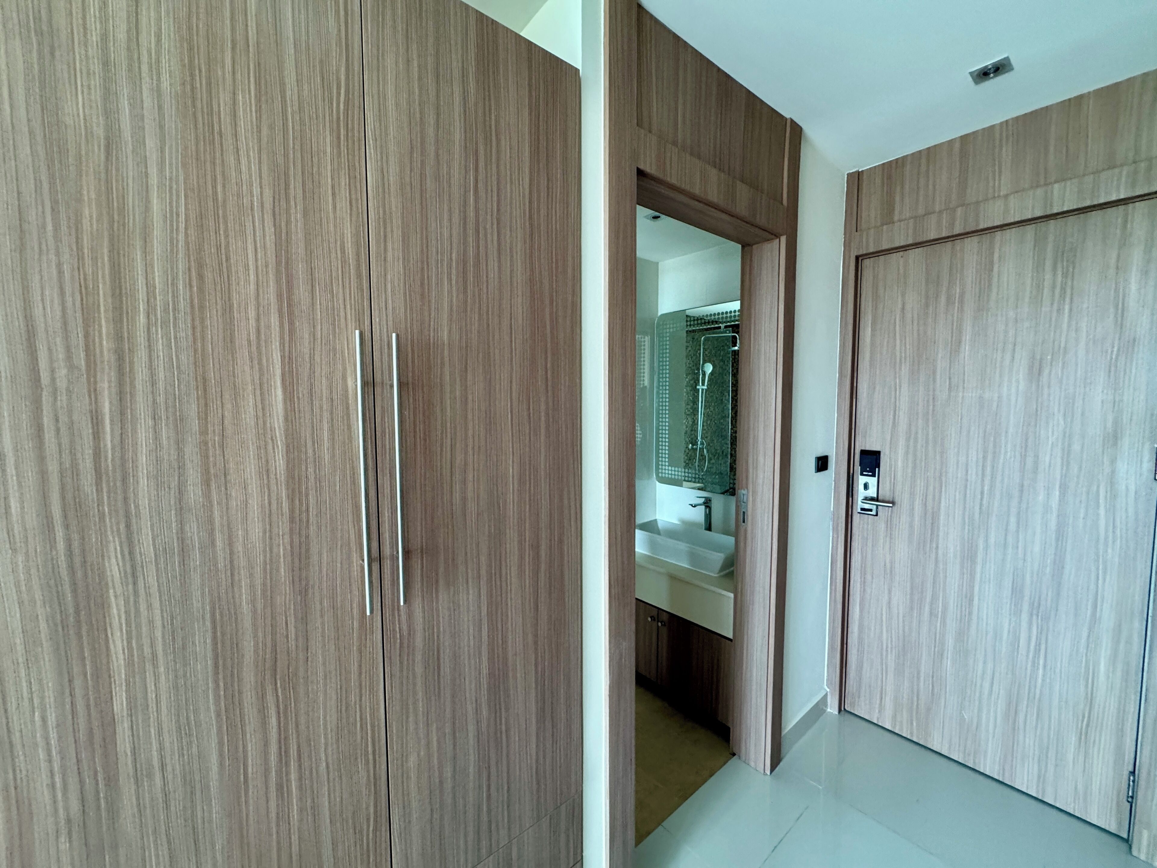 A modern bathroom with a shower, a sink, and a mirror.
