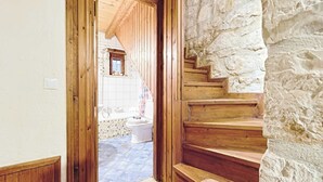 A stone staircase leading to a bathroom with a wooden door and a view of a stone wall. - Villa Poseidon - Executive Suite In Zante w/Pool (Skinaria)