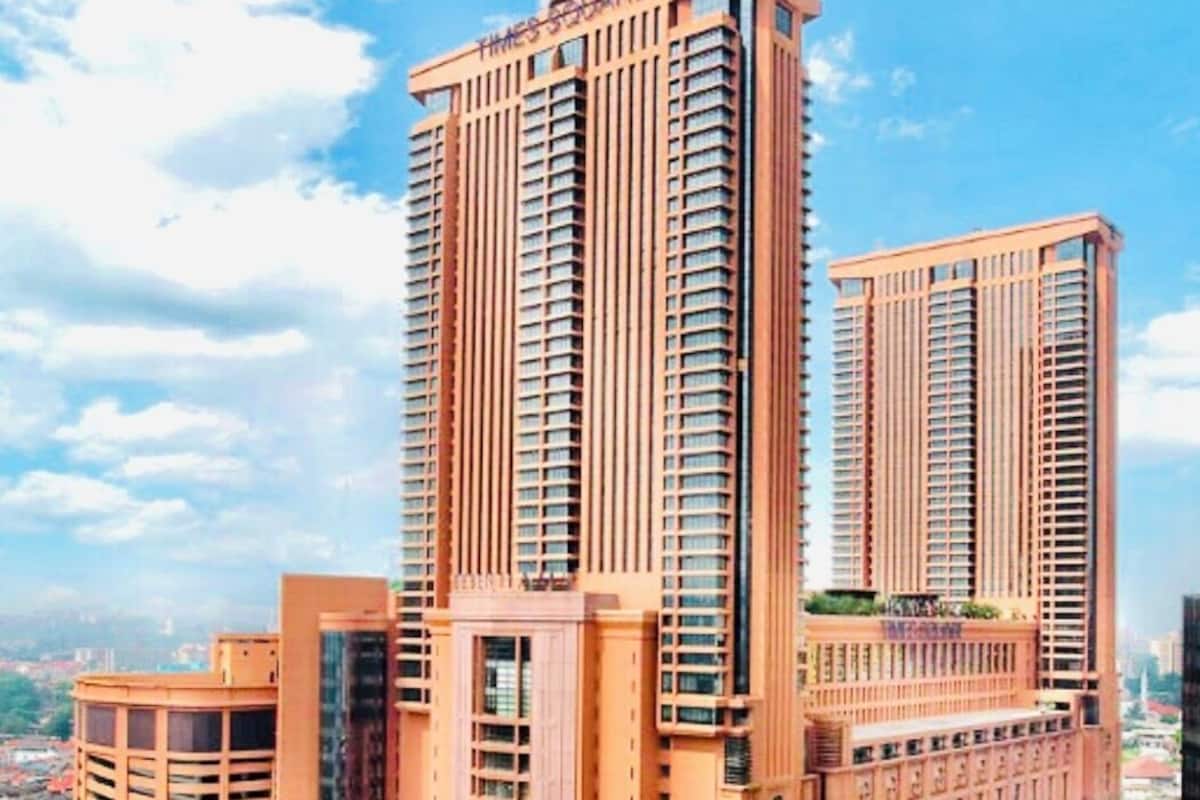 A high-rise building with multiple floors, large windows, and a prominent entrance.