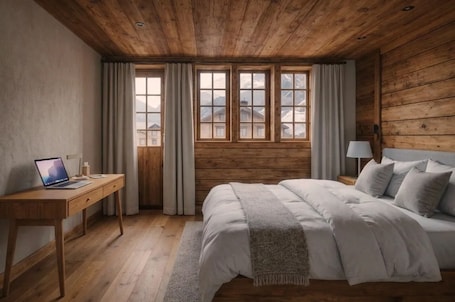 Une chambre avec un plafond en bois, un lit avec des oreillers, un bureau avec un ordinateur portable et une fenêtre avec des rideaux.. Le Rucher dEvolene