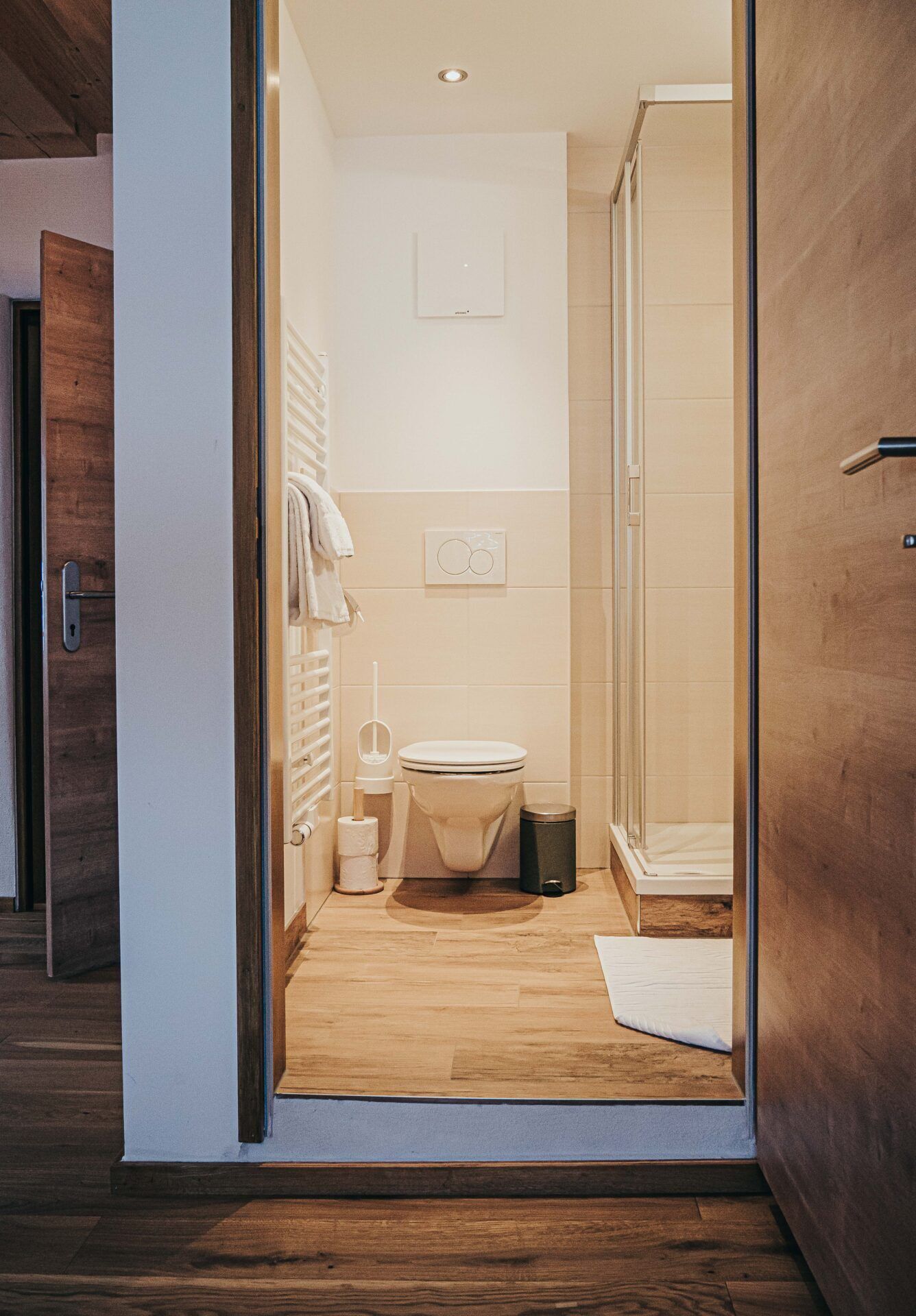 A modern bathroom with a toilet, bidet, and shower.