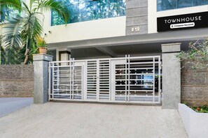 A gated entrance to a building labeled 'TOWNHOUSE #19' with a company-serviced sign. - Deluxe With Twin Bedhotel SPG Grand (Hyderabad)