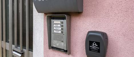A public telephone booth with a sign above it and a keypad below.