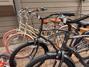 A bicycle with 'PRIORITY' written on the frame, leaning against a building.