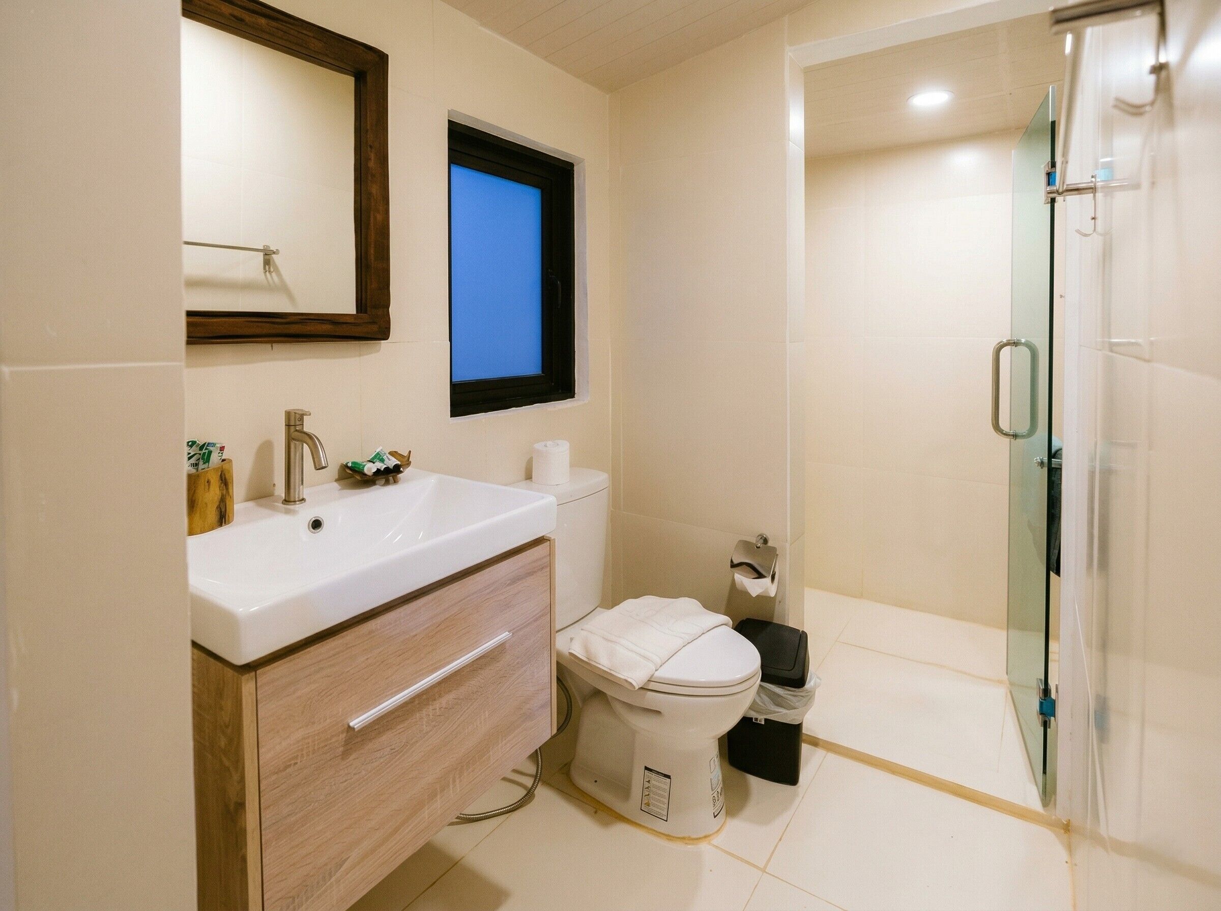 A bathroom with a sink, toilet, and shower.