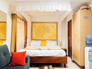 A hotel room with a bed, a sofa, a wardrobe, and a water dispenser. - Beautiful studio in Nairobi perfect for your city getaway.
5 minutes from CBD (Nairobi)