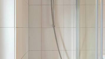 Shower, hair dryer, towels, shampoo