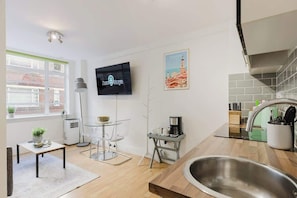 A modern kitchen with a built-in stove, a coffee machine, and a sink. - Superb 1BR w/AC - Chelsea (Greater London)