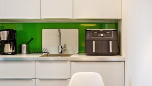 A kitchen with a coffee maker, a water dispenser, and a sink. - Holiday Home "Am Ritzberg 2" with Shared Garden and Wi-Fi (Beverungen)
