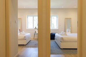 Ein Hotelzimmer mit zwei Betten, einem großen Spiegel und einem Fenster.