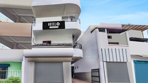 A multi-story hotel with a sign reading 'HOTELO & Company-Serviced.' - Deluxe Bhagwan Guest House (Dehradun)