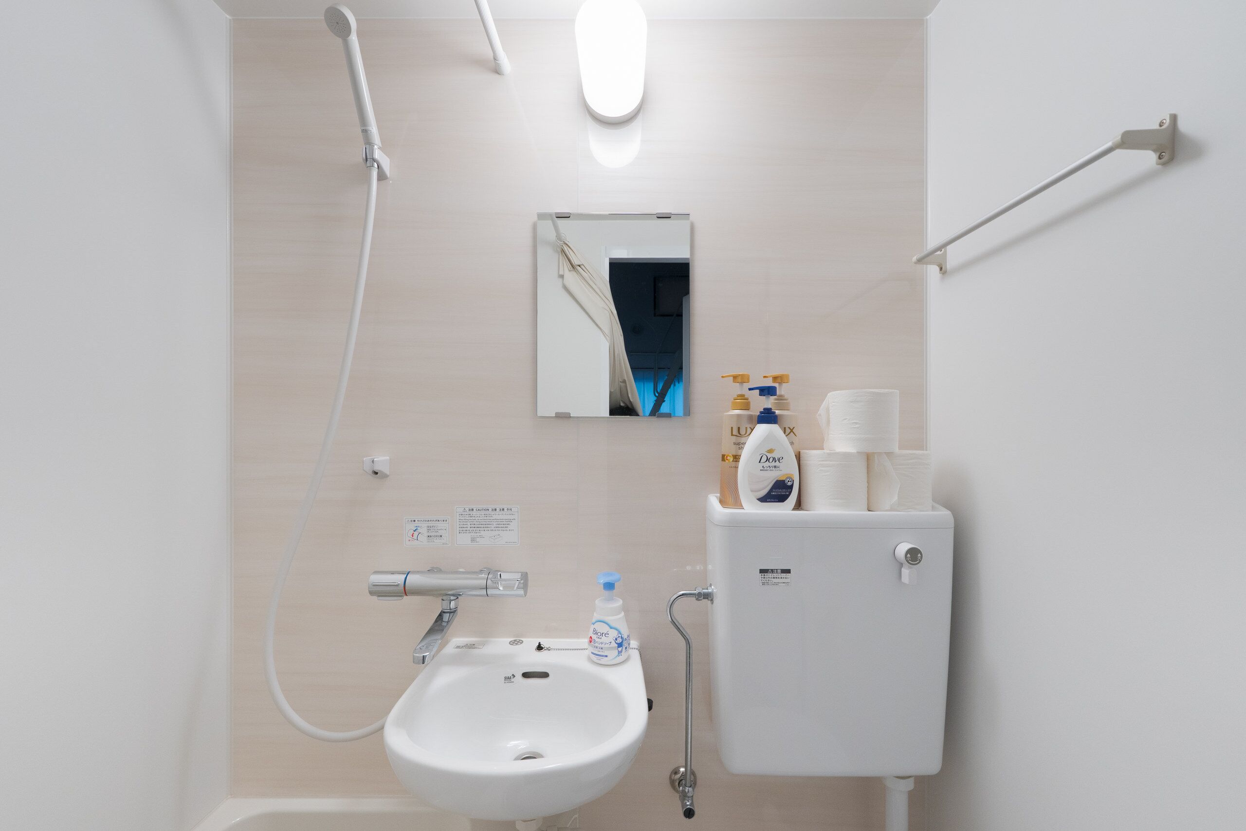 A bathroom with a sink, toilet, and shower.