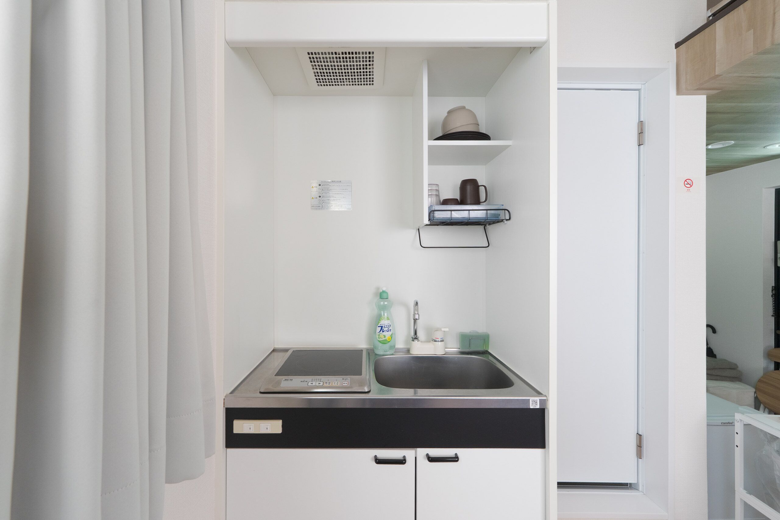 A compact kitchen with a dishwasher, a sink, and a small countertop.