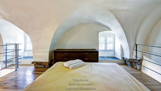A bedroom with a bed, a dresser, and a window. - Grace house (CIVEZZA)