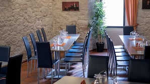 A conference room with long tables, chairs, and a potted plant. - Accessible Double Room (Schlitz)