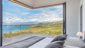 A bedroom with a large window overlooking a coastal landscape. - Panoramic sea view - heated pool - comfort (Coti-Chiavari)