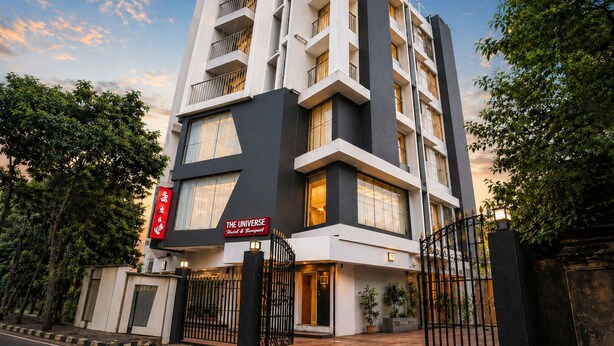 A multi-story hotel with a modern design, featuring balconies and large windows. - The Universe (Kolkata)