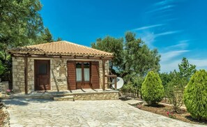 A stone building with a tiled roof, wooden shutters, and a stone-paved entrance. - Villa Poseidon - Family Suite In Zante w Pool (Zakynthos)
