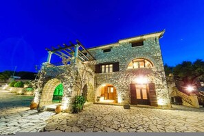 A stone building with arched doorways and a pergola. - Villa Poseidon - Master Suite In Zante w Pool (Zakynthos)