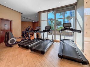 A gym with treadmills, stationary bikes, and elliptical machines. - Free Housekeeping Visits During Your Stay - Stayshort - Studio in Business Bay With Modern Amenities That Sleeps 4 (Dubai)