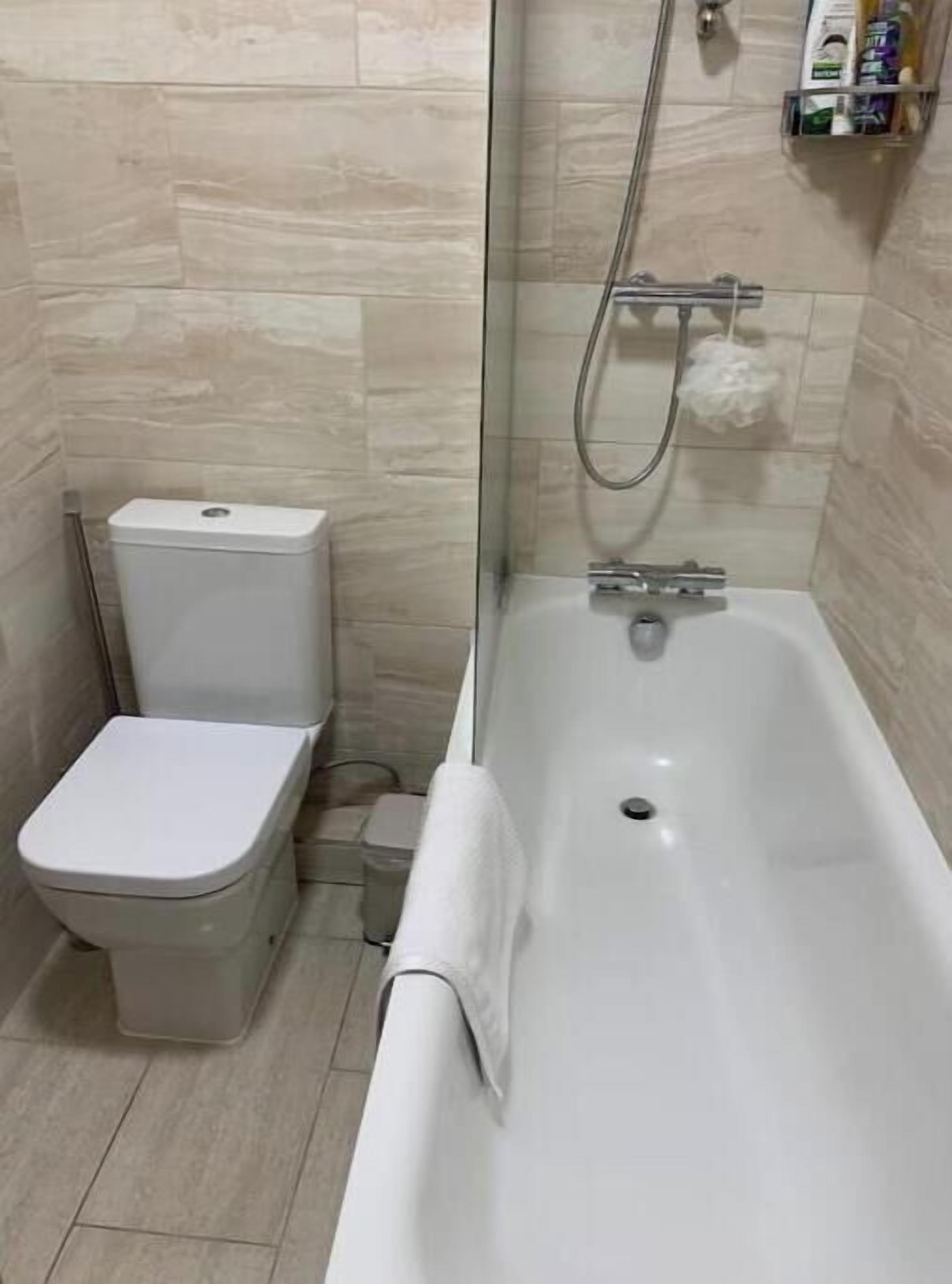 A bathroom with a toilet, a shower, and a bathtub.