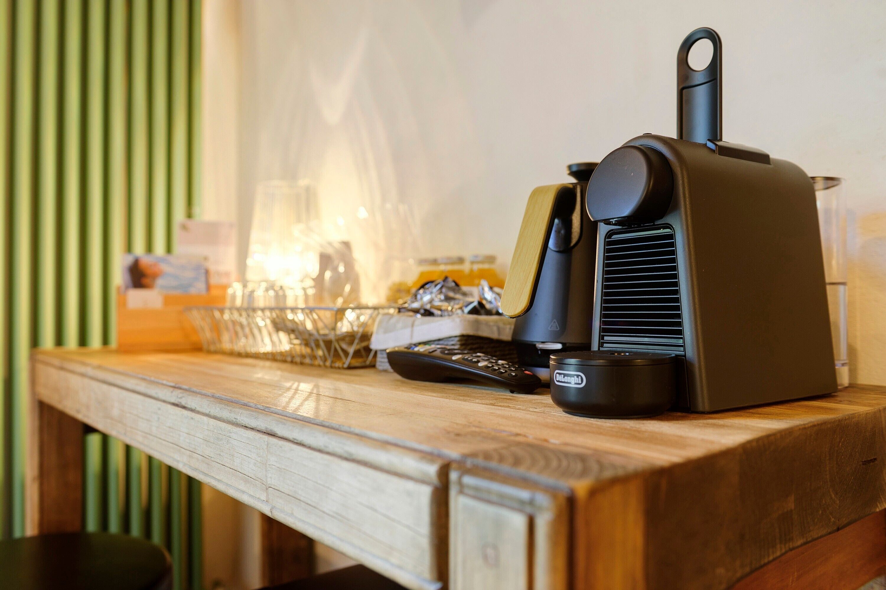A kitchen counter with a coffee maker, a bowl, and a jar.