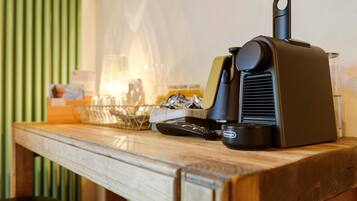 A kitchen counter with a coffee maker, a bowl, and a jar.
