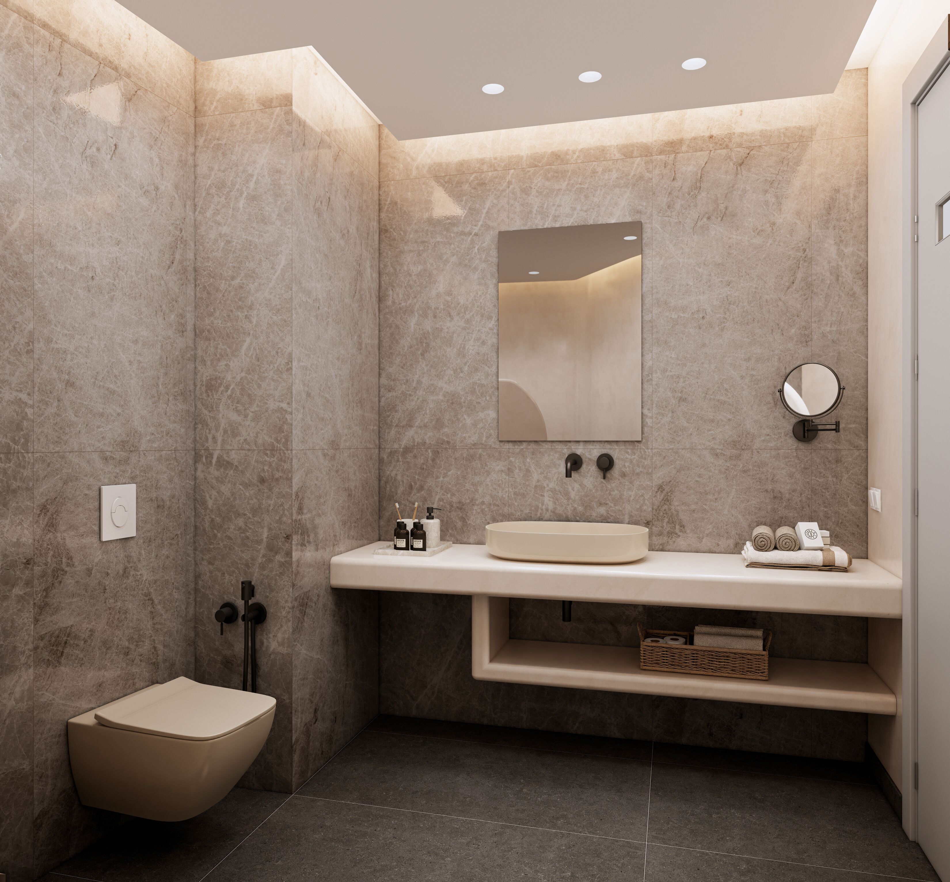 Un baño moderno con un lavabo color beige, un espejo redondo y un inodoro.