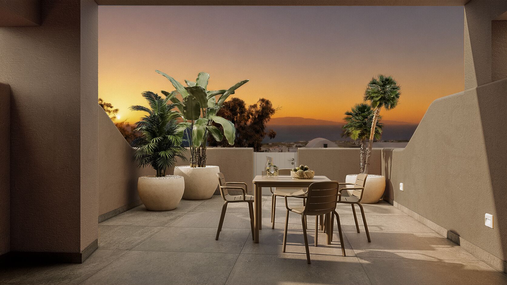 Une terrasse avec une table et des chaises, des plantes en pot et une vue sur le coucher de soleil.