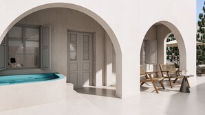 A modern outdoor pool area with a hot tub, wooden chairs, and a cactus wall. - Terracotta Sunset Suites (Oia)