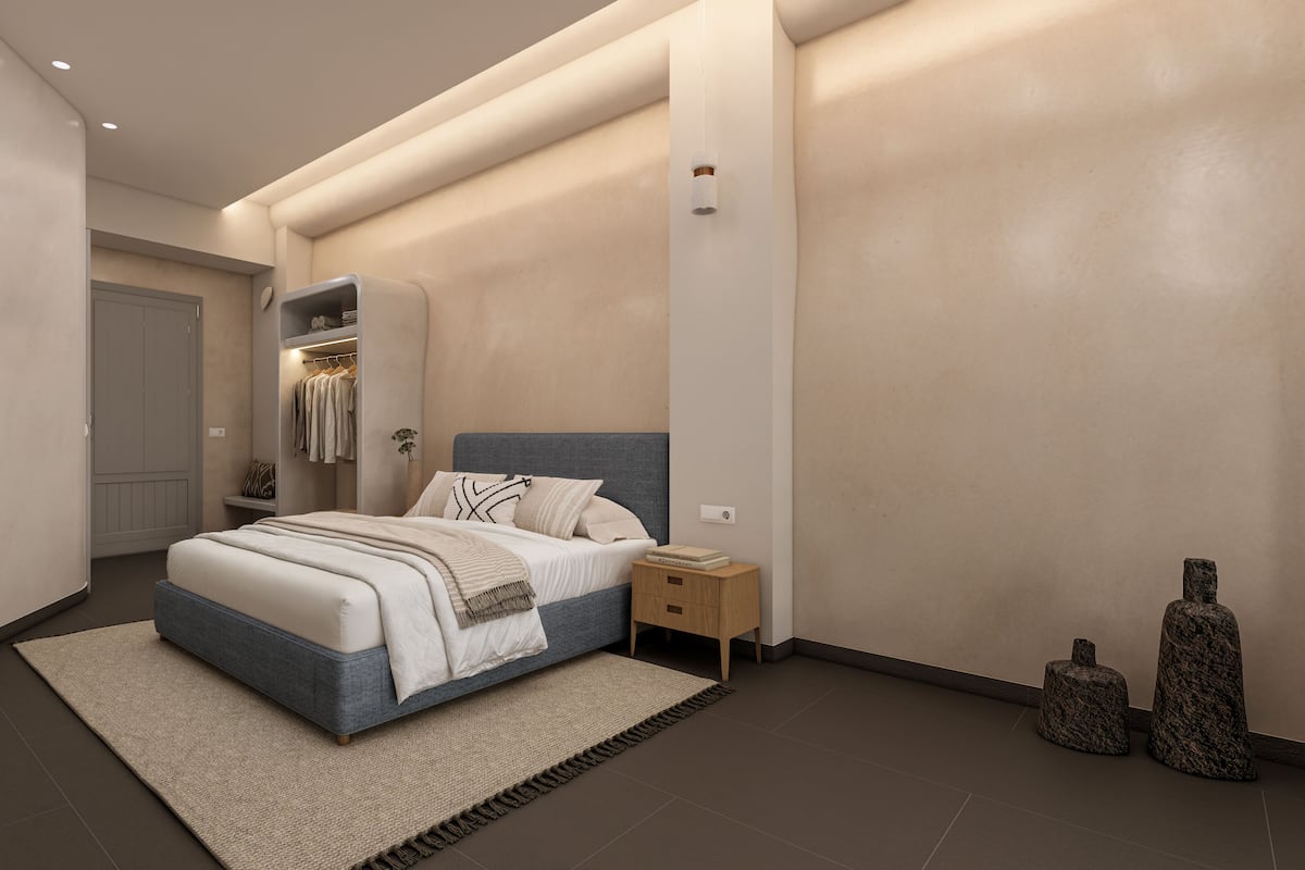 Ein modernes Schlafzimmer mit Bett, Nachttisch und begehbarem Kleiderschrank.