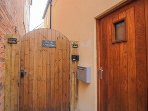 A wooden gate with a sign reading 'The Old China Shop.' - The Old China Shop (Ludlow)