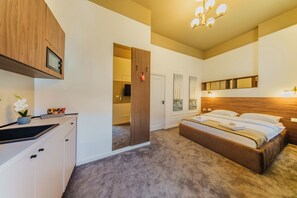 A bedroom with a bed, a wooden cabinet, a mirror, and a door leading to another room.
