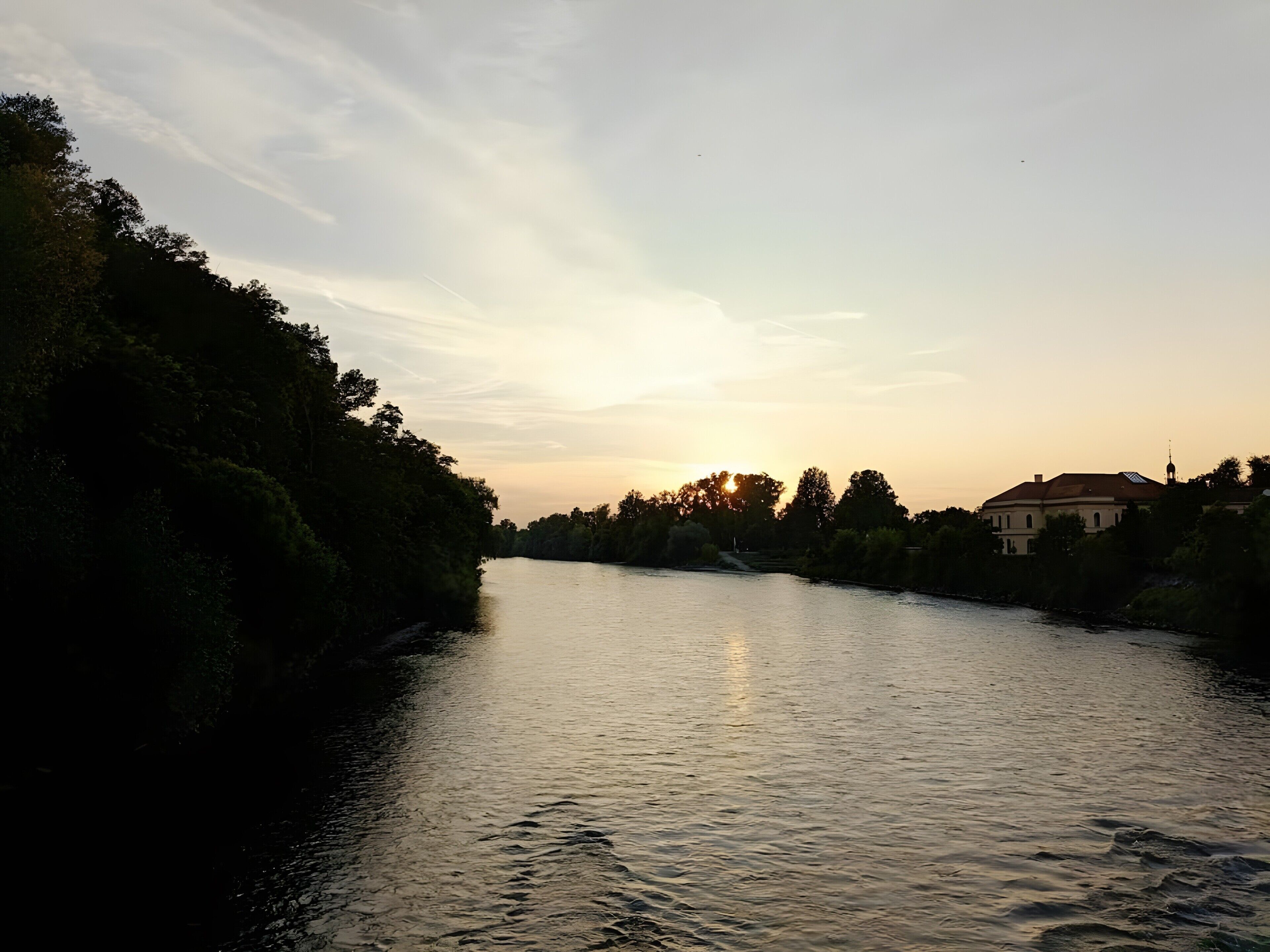 A river with a building on the right bank.