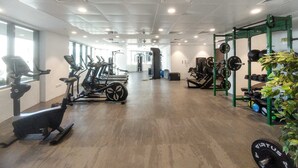 A gym with treadmills, stationary bikes, and weightlifting equipment. - Silkhaus Ajwan 1BD Mamsha Beach Access (Abu Dhabi)