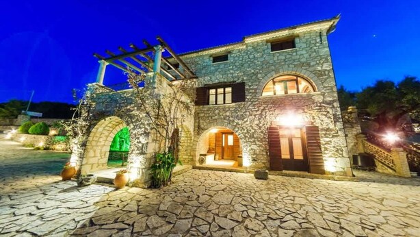 A stone building with arched doorways and a pergola structure. - Villa Poseidon - Superior Suite In Zante w Pool (Zakynthos)