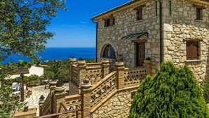 A stone building with a balcony overlooking a body of water. - Villa Poseidon - Superior Suite In Zante w Pool (Zakynthos)