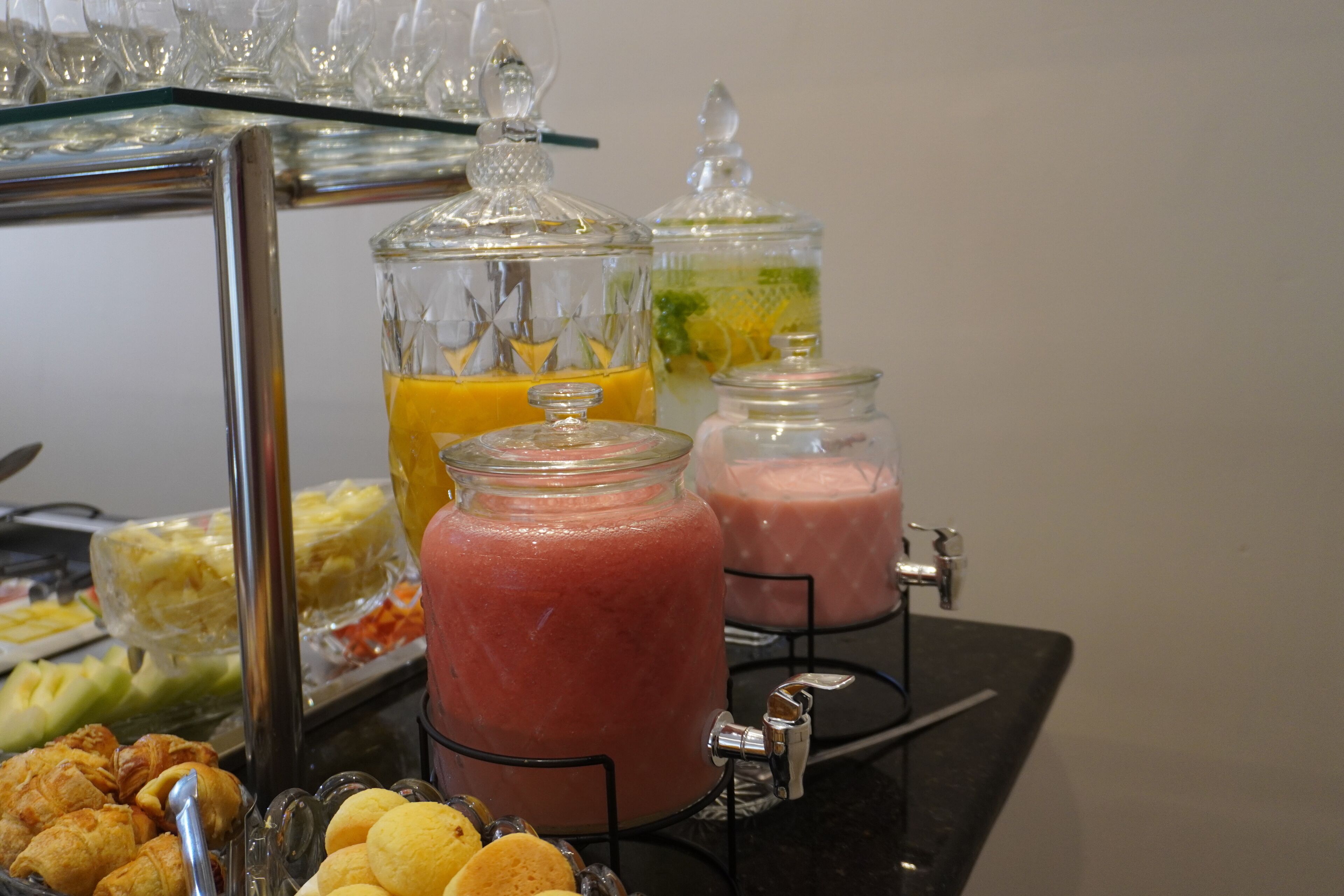 A buffet table with various food items and beverage dispensers.