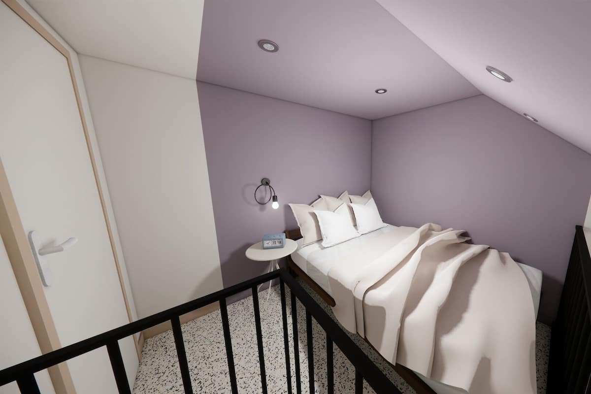A bedroom with a bed, a nightstand, a wall-mounted light, and a staircase.