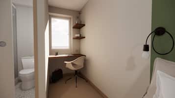 Un baño con inodoro, ducha, lavabo y una silla.
