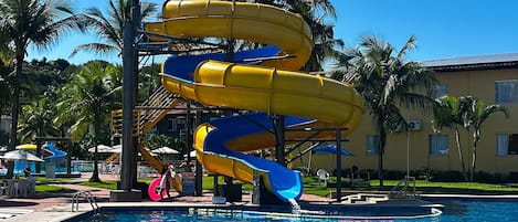 A water park with multiple slides and a swimming pool.