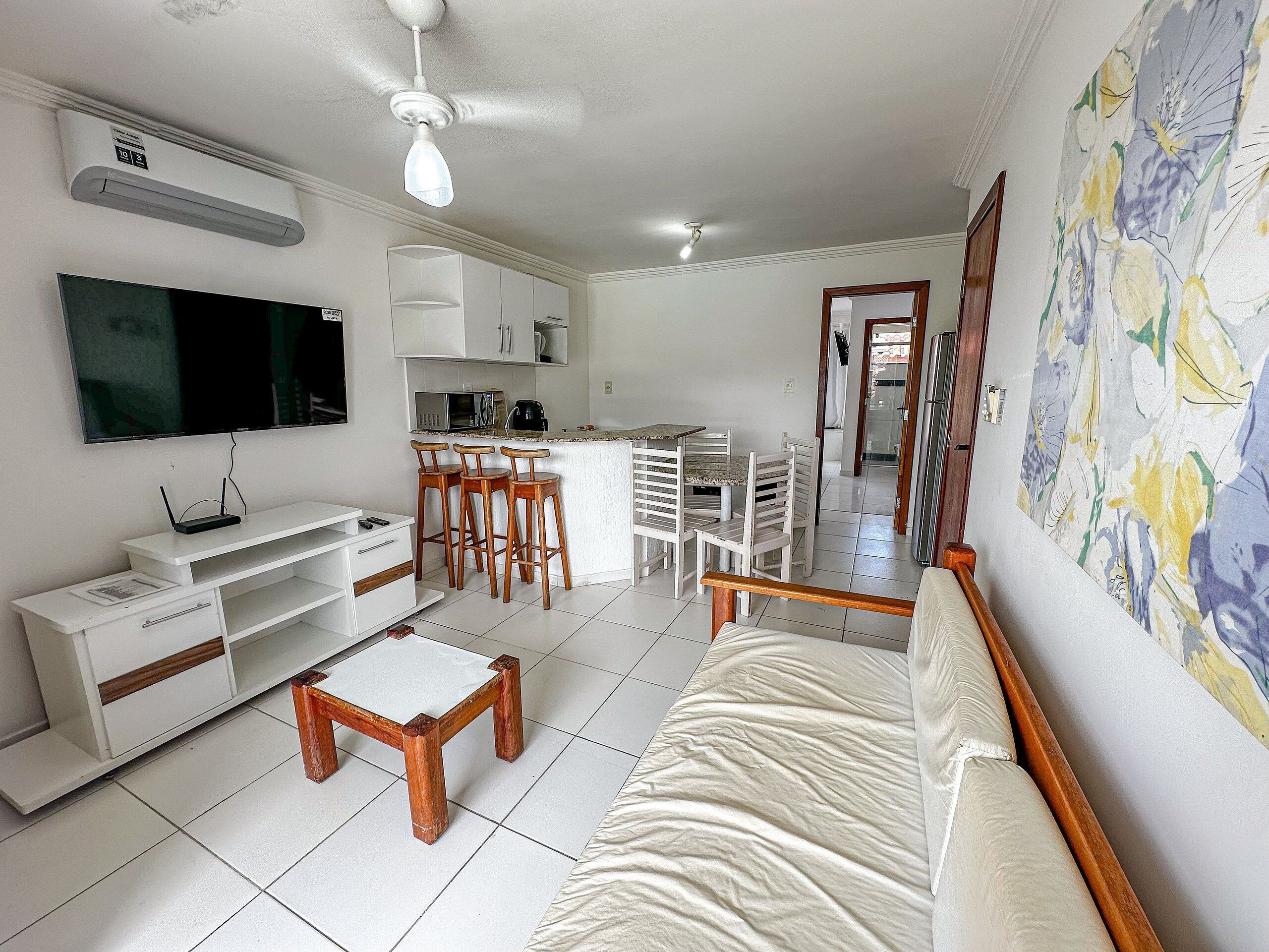 A compact living space with a kitchenette, a dining area, and a seating area.