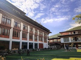 A traditional building with large windows and a courtyard.