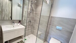 A modern bathroom with a glass-enclosed shower, a white sink, and a toilet. - Fouka North Coast SA-8A-G03 (Marsa Matrouh)