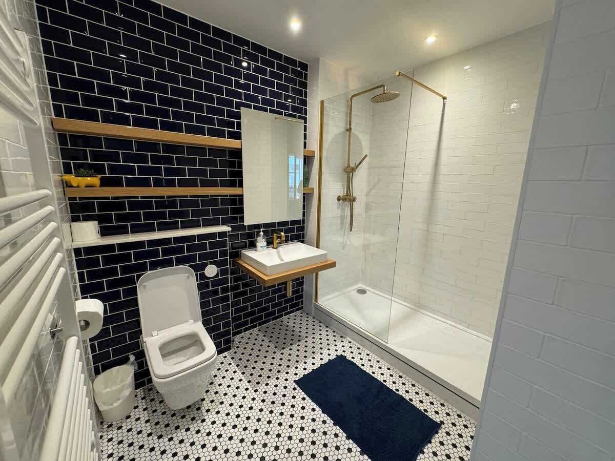 A bathroom with a toilet, sink, and shower.