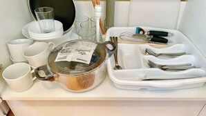 A kitchen counter with a pot, cups, a tray with utensils, and a glass. - Studio flat en-suite, Kitchenette, Parking, NP7 (Newbury Park)