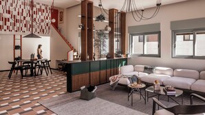 A modern living room with a sofa, coffee table, and dining area. - Hayarkon 70 - Boutique Aparthotel (Tel Aviv)